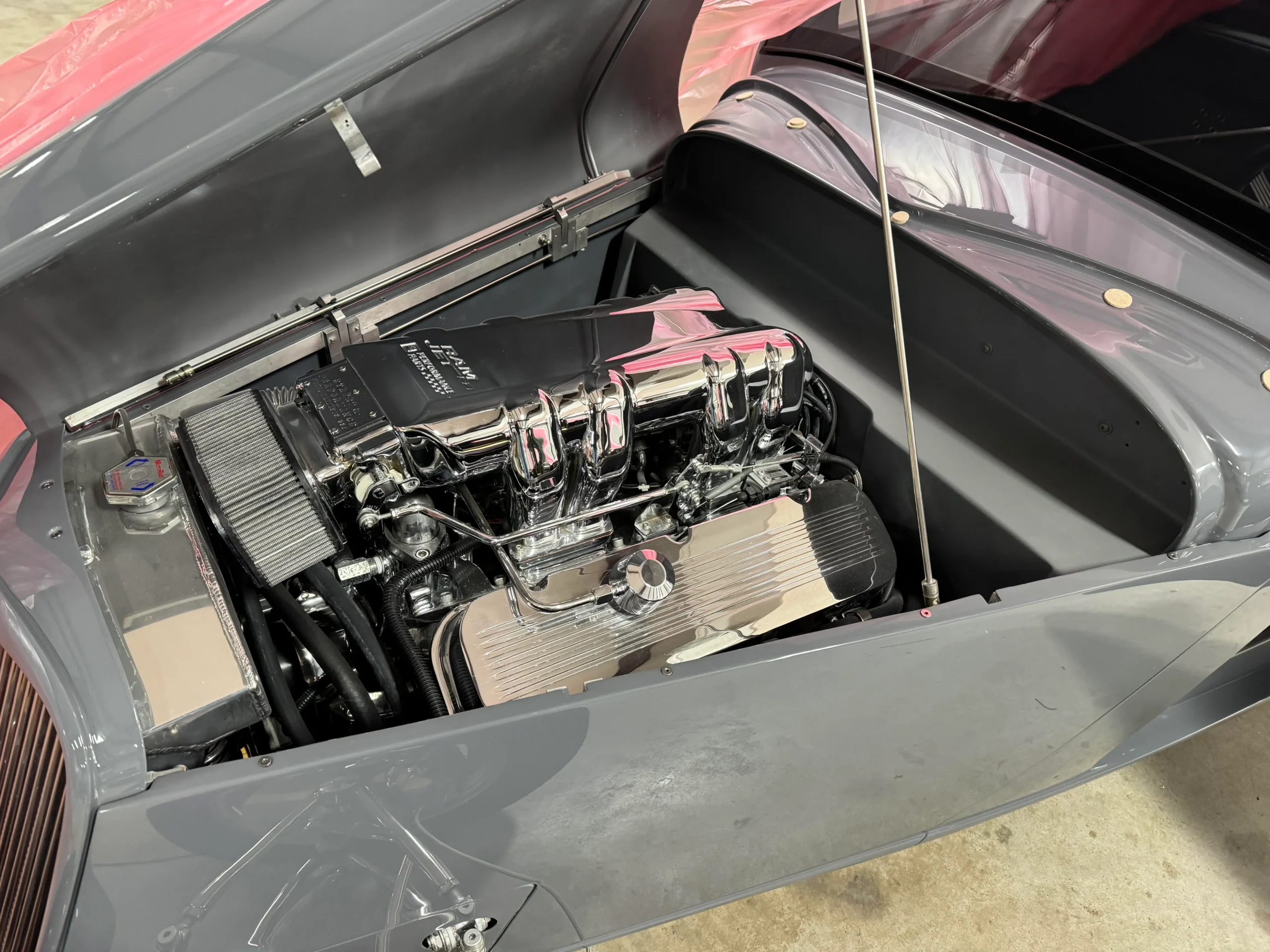 1933 Ford Coupe custom restoration with gray paint, polished wheels, wide rear tires, and classic hot rod styling