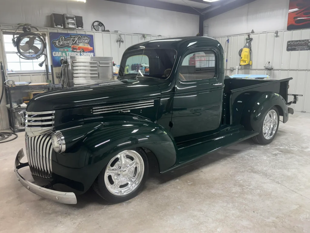 1946 Chevrolet Truck full restoration with deep green paint, chrome grille details, and polished wheels