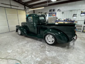 1946 Chevrolet Truck full restoration with deep green paint, chrome grille details, and polished wheels