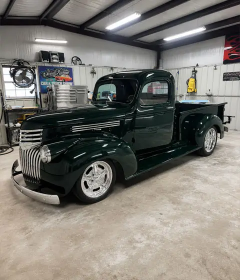 1946 Chevrolet Truck full restoration with deep green paint, chrome grille details, and polished wheels