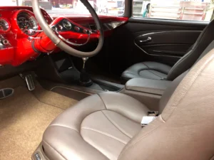 1957 Chevrolet 2-Door Hardtop custom interior with red dash, updated gauges, and modern shifter