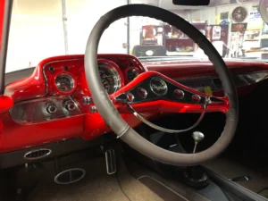 1957 Chevrolet 2-Door Hardtop dashboard with red paint, custom gauges, and restored interior details