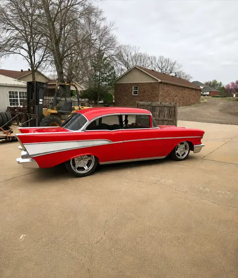 1957 Chevrolet 2-Door Hardtop complete restoration with red paint, chrome trim, and polished wheels