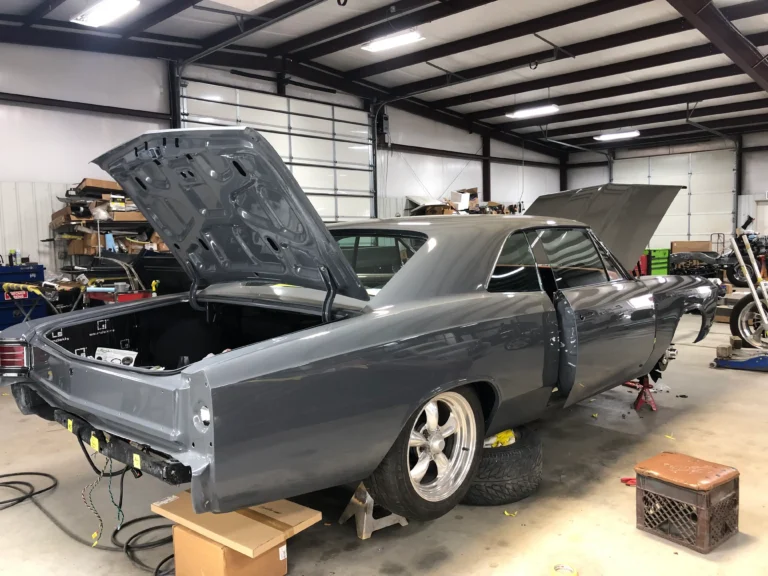 1967 Chevrolet Chevelle complete restoration with gray paint, open trunk, polished wheels, and shop progress