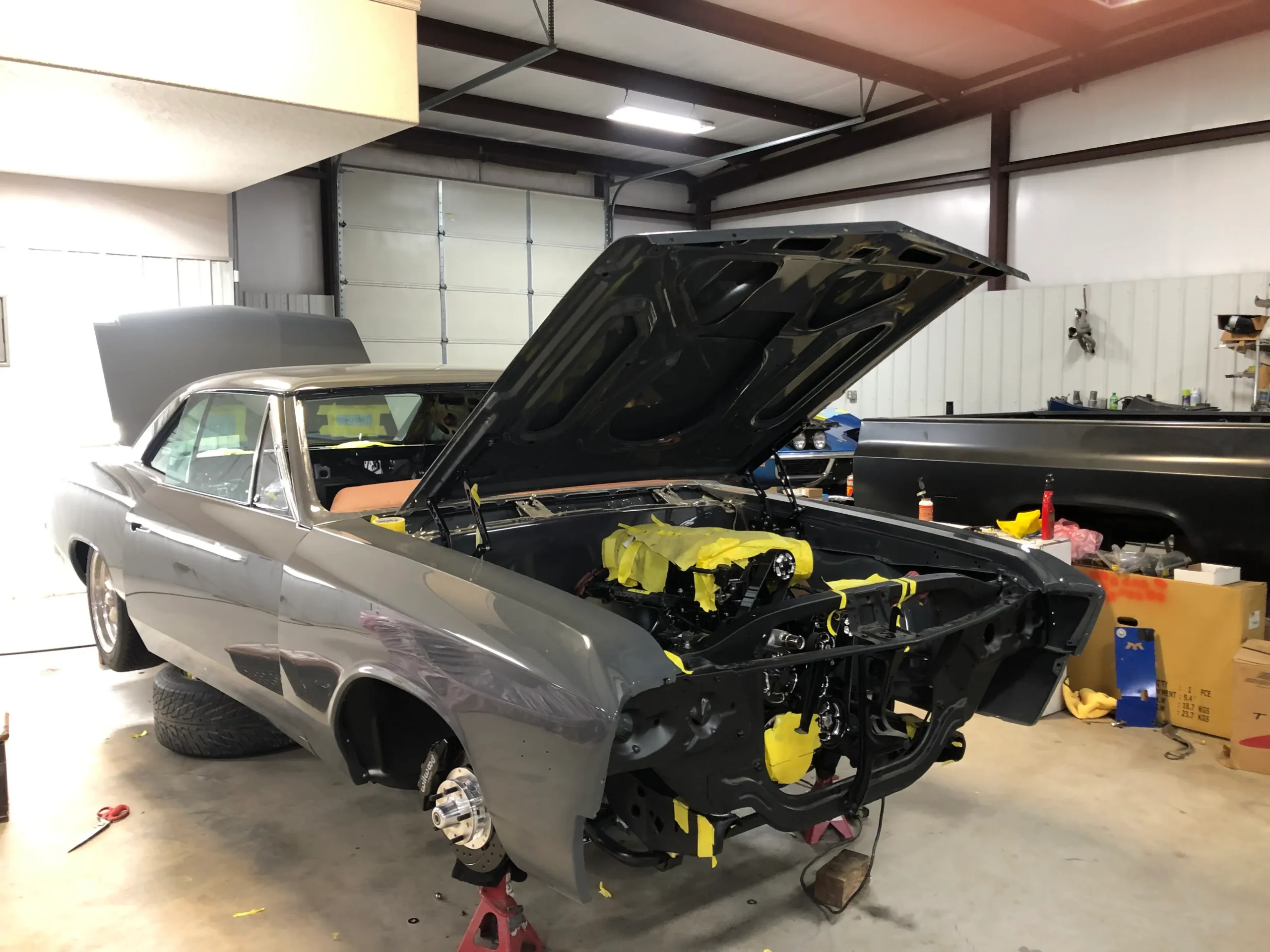 1967 Chevrolet Chevelle restoration with open hood, gray paint, updated suspension, and engine bay work