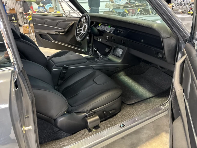 1967 Chevrolet Chevelle custom interior with black seats, modern console, updated gauges, and restored door panels