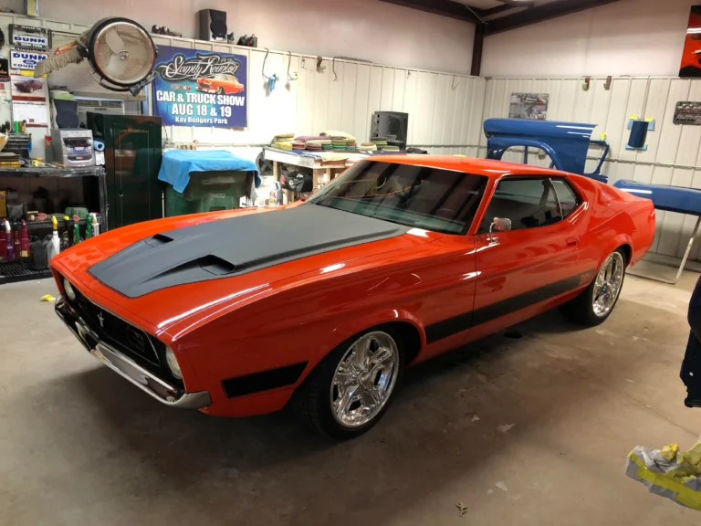 Custom built 1973 Ford Mustang Mach 1 full restoration with orange paint, black hood, and chrome wheels