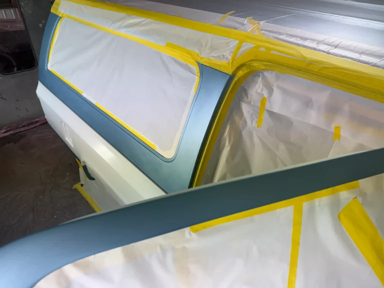 1991 Suburban restoration paint prep showing masked body panels and two-tone exterior detail