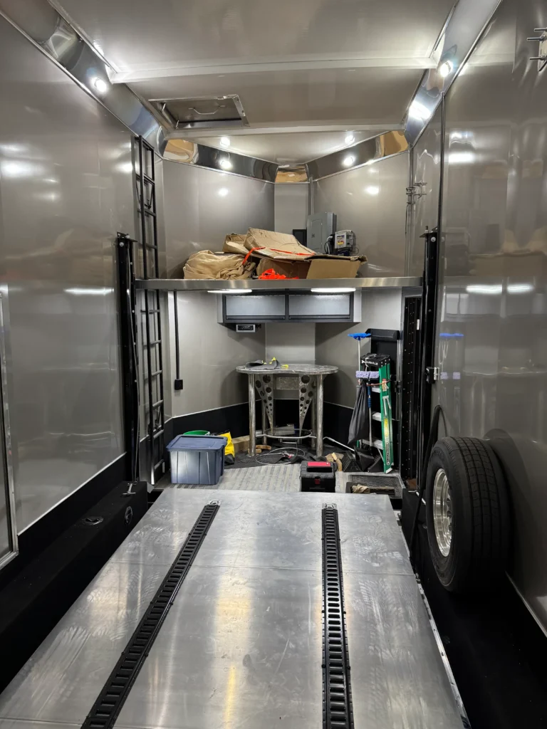 2019 Renegade Enclosed Stacker Trailer interior with rear loading area, lighting, and equipment space